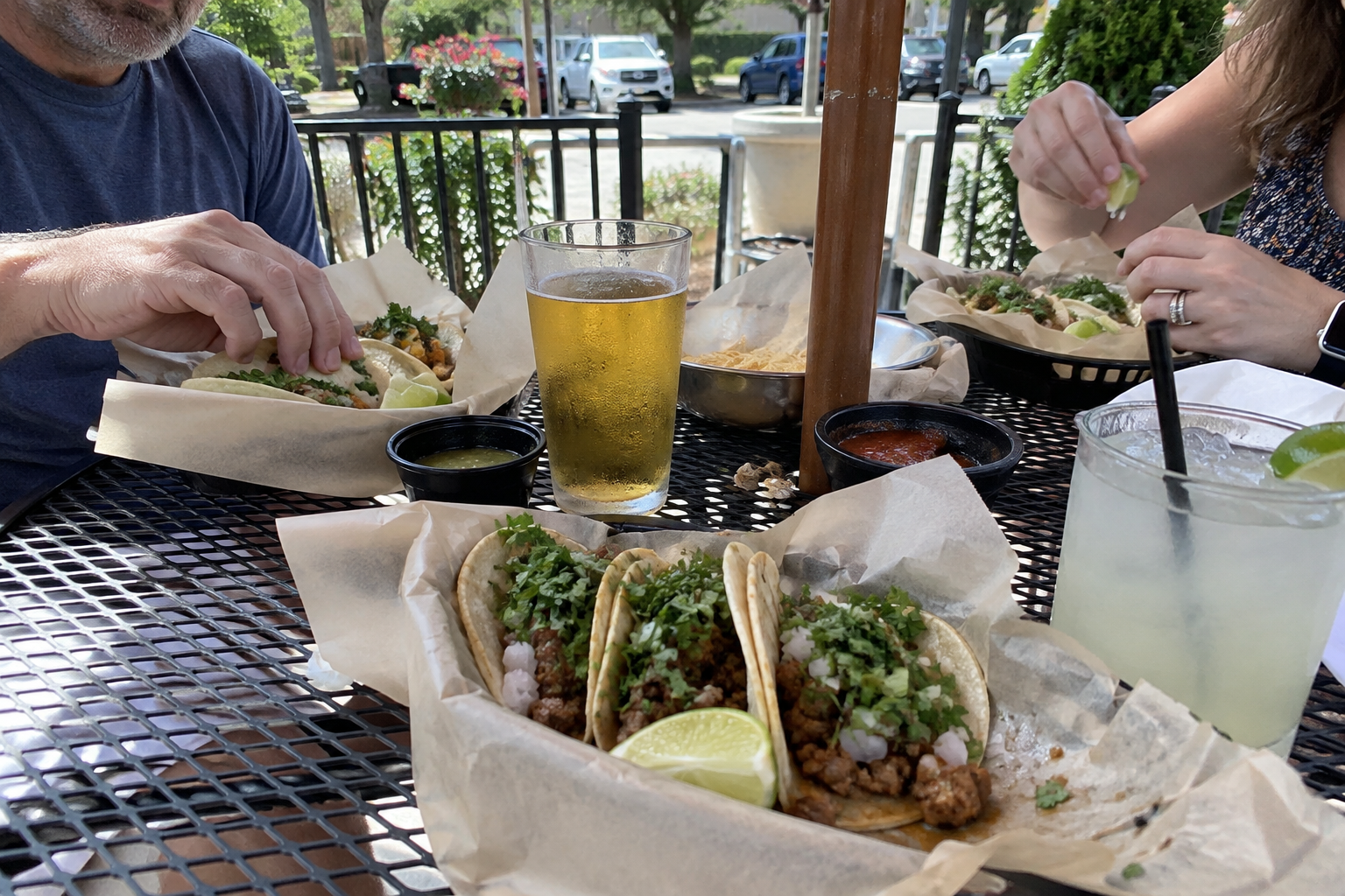 Friends sharing tacos on a sunny patio